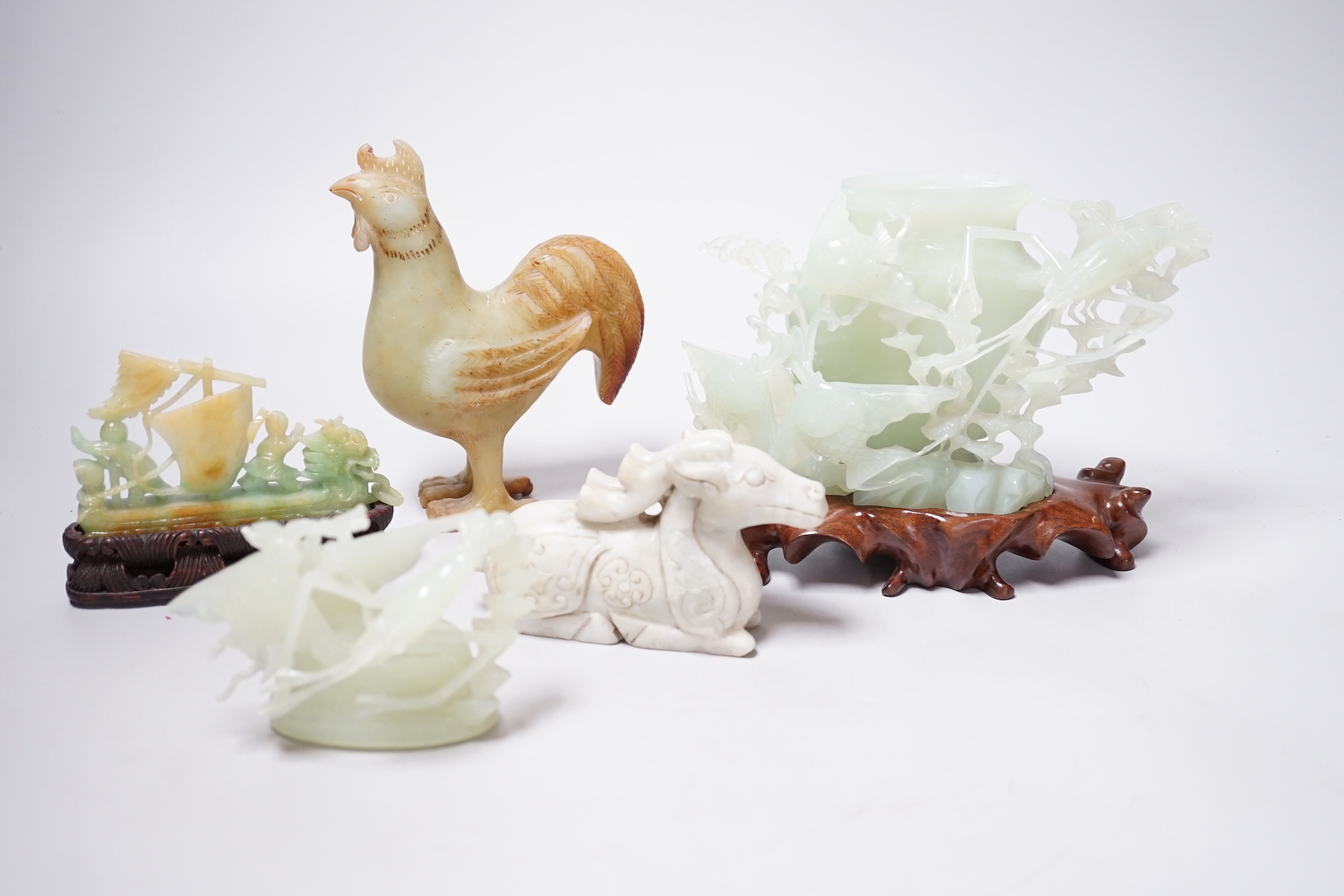 A group of four Chinese bowenite jade and hardstone carvings, the ‘sea creatures’ vase and cover, 18 cm high excluding wood stand